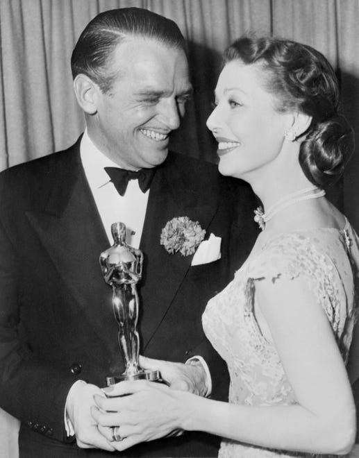Douglas Fairbanks Jr. accepts the best actor Oscar for his friend Laurence Olivier (for "Hamlet") from Loretta Young in 1949.