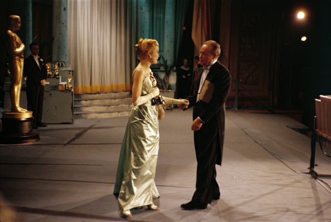 Best actress winner Grace Kelly (for "The Country Girl") onstage with Oscars host Bob Hope in 1955.
